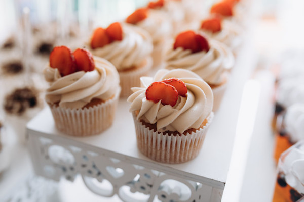 tasty-cupcake-with-creamy-topping-slice-strawberry-top-sweet-buffet_8353-10957